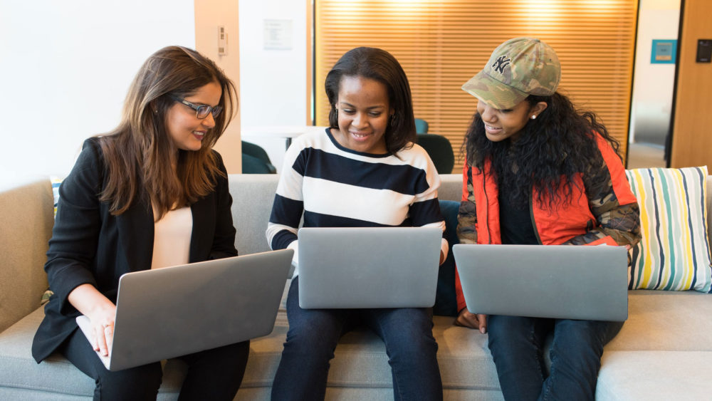 Three young woman on their laptops