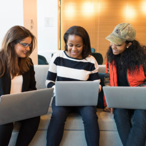 Three young woman on their laptops