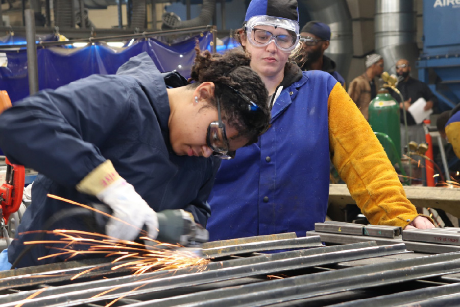 Two young women working in a steel fctory