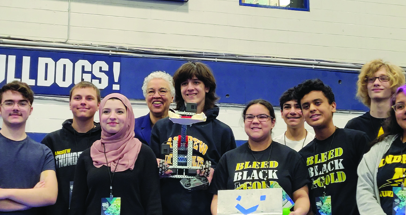 Group of young adults happily posing for a picture with Cook County Board President Toni Preckwinkle at a STEM event.