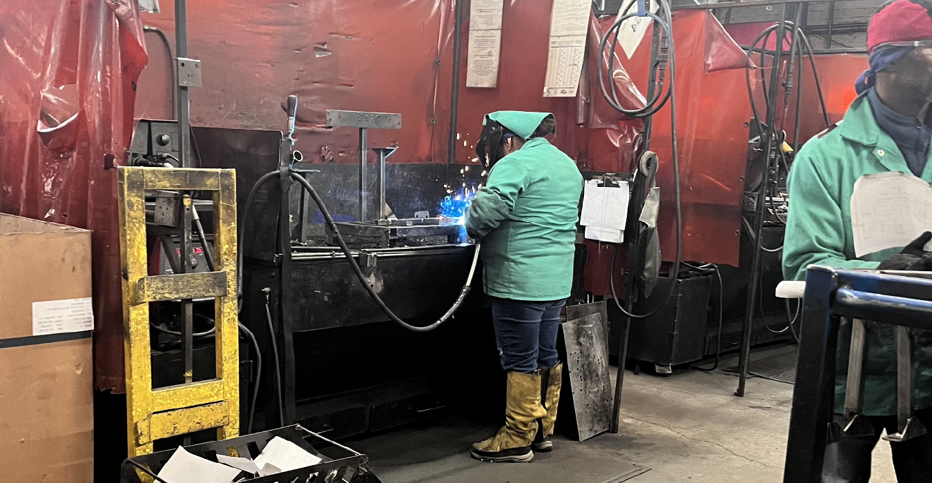 Picture of welders at work in protective gear.