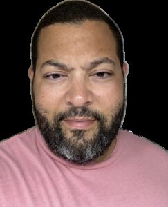 A photograph of a man with a beard and mustache.